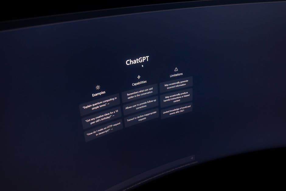 Close-up of a computer screen displaying ChatGPT interface in a dark setting.